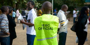 An IEBC official coordinates voters at a polling station in Kenya.