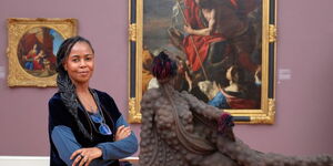 Photo of Wangechi Mutu Next to her Art