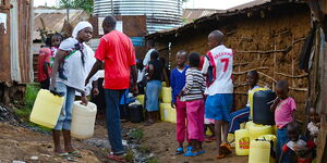 people lining at a water tap to fetch water in Kibera, Nairobi.