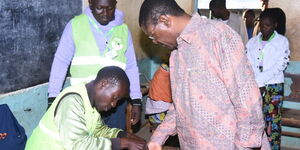 NA Speaker Moses Wetangula verifying voter details at IEBC biometrics kit on December 8, 2022
