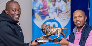 Britam official handing an award to one of the winners of the Britam Golf Circuit on June 17, 2024