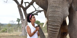 Wildlife filmmaker and conservationist Paula Kahumbu next to an elephant