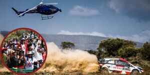 A photo of a helicopter monitoring a safari rally car in 2021 in Naivasha and rally enthusiasts at the event held on June 27, 2022