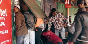 A section of Kenyan youth pictured gaining entry into a shop