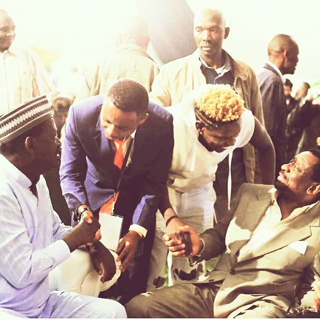 Fred Omondi (second right) shakes Siaya Senator James Orengo's hand as Raila Odinga (left) interacts with another emcee in an event in 2018