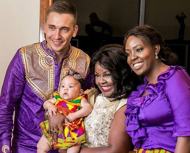 From left: Robert Kovac, Kathy Kiuna, Vanessa Kovac pose for a photo with a child born to Robert and Vanessa.