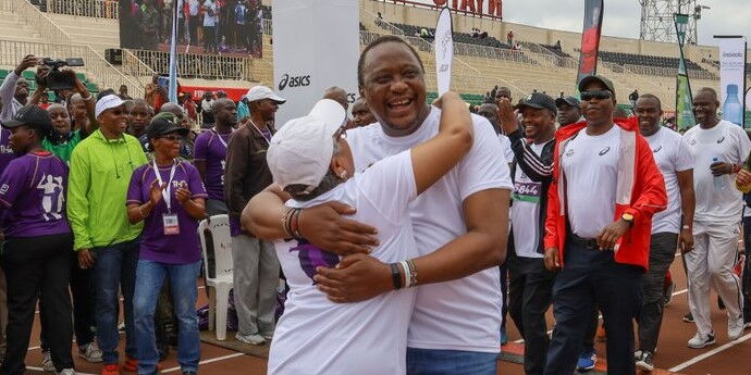 President Uhuru Kenyatta embraces his wife Margaret after completing his 2km run at the beyond zero half marathon on March 8, 2020.