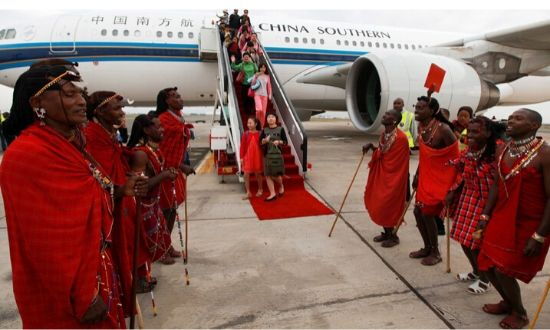 Traditional Kenyan Masaai dancers welcome Chinese tourists disembarking from a China Southern Airlines plane at Jomo Kenyatta International Airport in Nairobi, Kenya on Aug 5, 2015