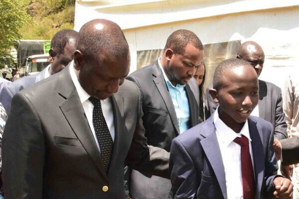 Deputy President William Ruto with Sergeant Kipyegon Kenei's son in Nakuru County on Saturday, March 7, 2020