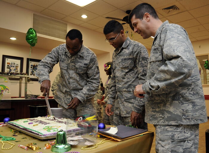 Airman 1st Class Kevin Yator (L) cuts a birthday cake during the Airmen Birthday Meal at the Barksdale Air Force Base in Los Angeles California.