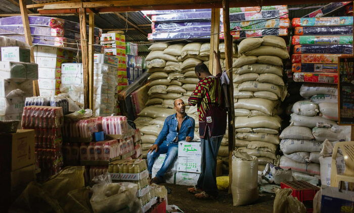 Mesfin Gatahun (left) in his retail wholesaler in Kakuma Refugee camp.