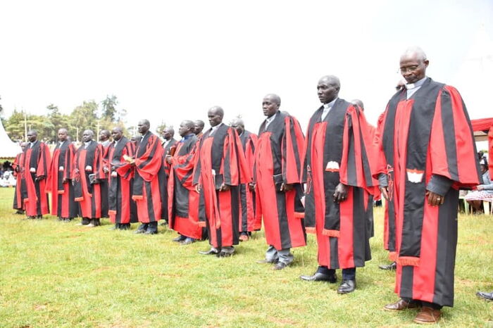 Morkomen's dad second right with other ministers ordained with him