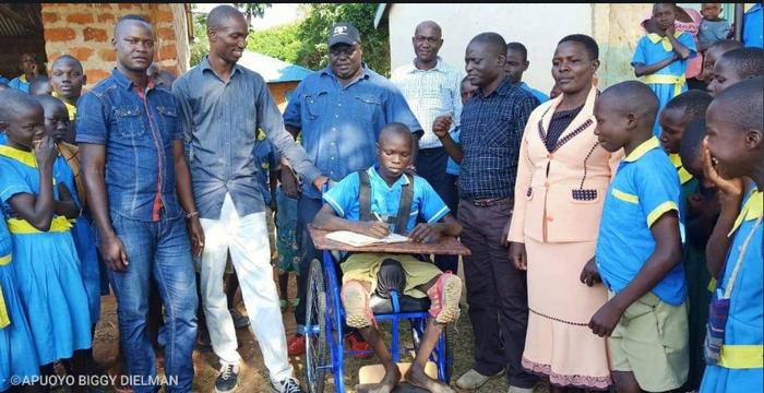 Gilbert Otieng' gets a wheelchair from well-wishers.