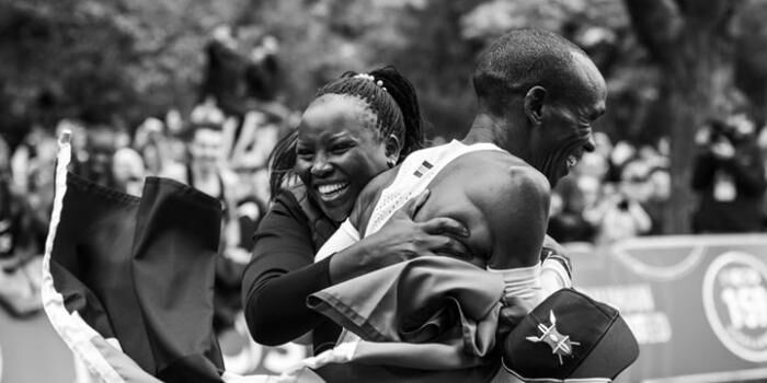 Eliud Kipchoge and wife embrace after he successfully ran a 42-kilometre race in under 2 hours. (Courtesy)