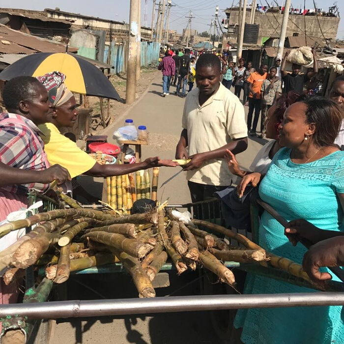 Nominated Senator Millicent Omanga at the market buying sugar cane