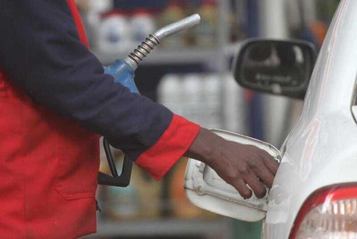 This image has an empty alt attribute; its file name is a_fuel_attendant_pumps_fuel_into_a_customers_car_nairobi_0.jpg