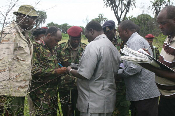 A security team exchanges notes at Bujara Ranch in Lamu County after five people were killed at Pandanguo in Witu, Lamu West, on June 23, 2014, when a gang armed with guns and machetes attacked villagers.