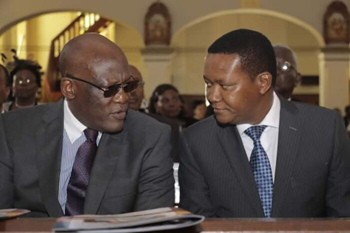 Governor Alfred Mutua and former Senator Johnson Muthama when they attended requiem mass for Samuel Mbova at St Austin church in Nairobi on Thursday. 