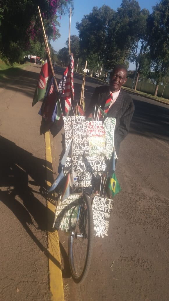 Nathan Ambuti pauses on his bicycle after his remarkable trip from Kakamega to Kabarak on February 11.