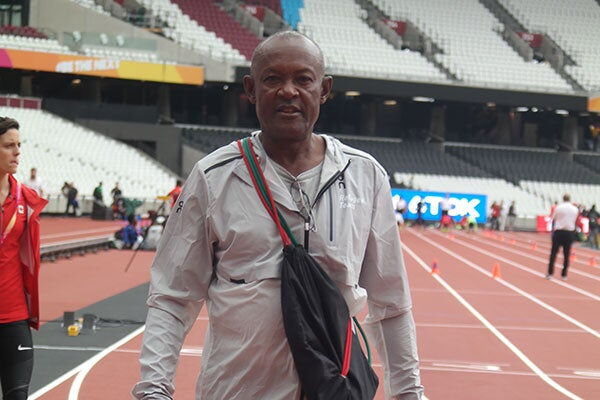John Anzrah, the head coach of the refugees team, has a feel of the Olympic Stadium track on Wednesday, August 3, ahead of the World Championships.