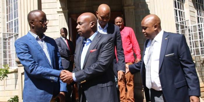 Baringo Senator Gideon Moi shakes hands with Raila Junior Odinga as KTN news host Tony Gachoka looks on at Parliament buildings on Monday, February 10