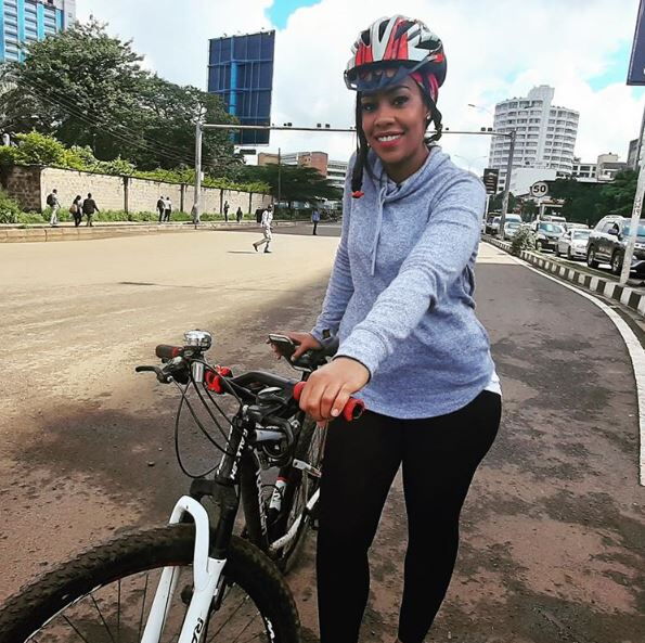 Celebrated journalist Victoria Rubadiri posing with her bicycle.