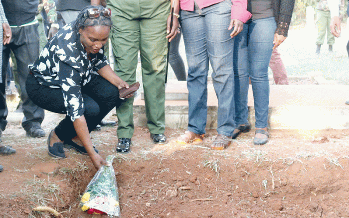 Sarah Wairimu laying flowers on her husband's grave. She lashed out at some family members accusing them of hypocrisy. Her speech has landed her into deeper trouble in court
