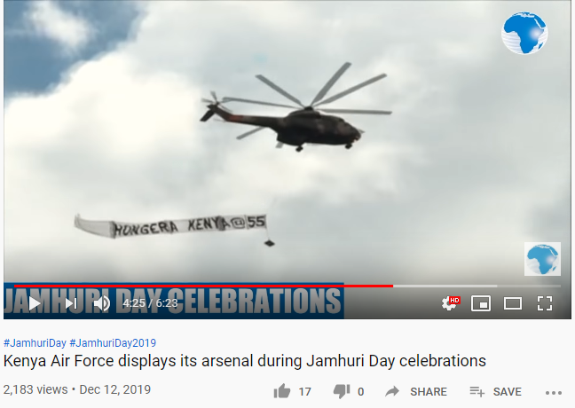 A screengrab of a military helicopter carrying a banner reading 'Hongera Kenya at 55' on December 12, 2019