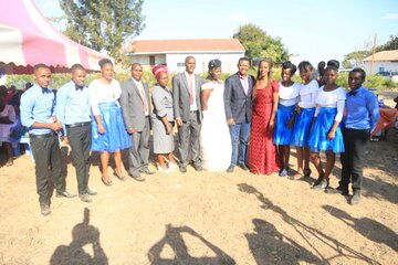 Governor Alfred Mutua and his wife pose for a picture with the bridal party 