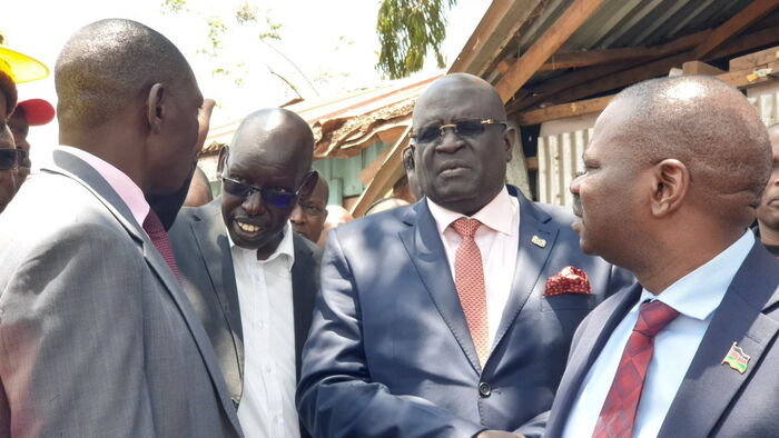 CS George Magoha (second right) and his PS Belio Kipsang at the Precious Talent School where a classroom collapse claimed eight lives. 