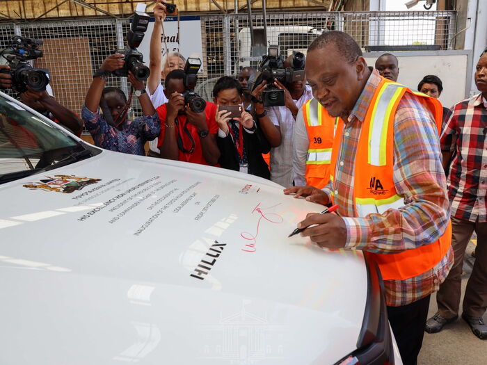 President Kenyatta on Friday October 18 signs a Toyota vehicle assembled in Kenya