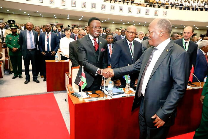 Ababu Namwamba(left) shakes hands with Tanzania president, John Pombe Magufuli(right) on November 8.