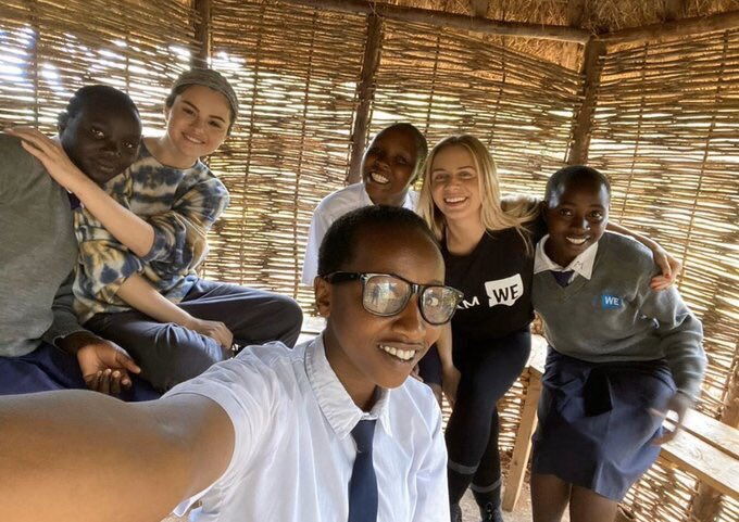 Selena Gomez (second left) poses for a selfie with children during her visit to Kenya in December 2019