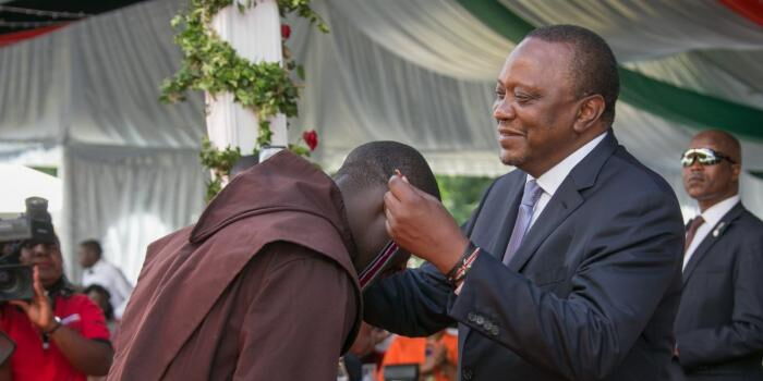President Uhuru Kenyatta honours Peter Tabichi with the MBS Award at State House on December 12, 2019
