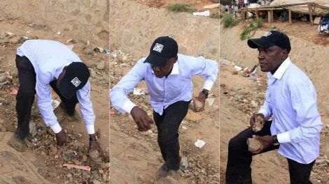 Former Senator Boni Khalwale collects stones to defend himself when rival groups of voters engaged each other at DC grounds in Kibera on November 7, 2019 during Kibra by-elections.