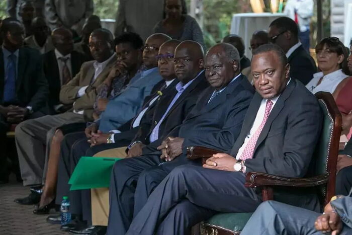 President Uhuru Kenyatta with retired President Mwai Kibaki who is seated next to his sons