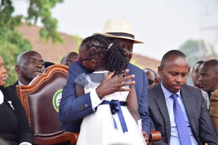 ODM Leader Raila Odinga embraces seven-year-old Abilisha Muthoni after a moving tribute on Friday, September 27. He was called out for an empty promise
