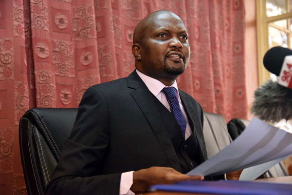 Moses Kuria addressing a past press conference at Parliament buildings