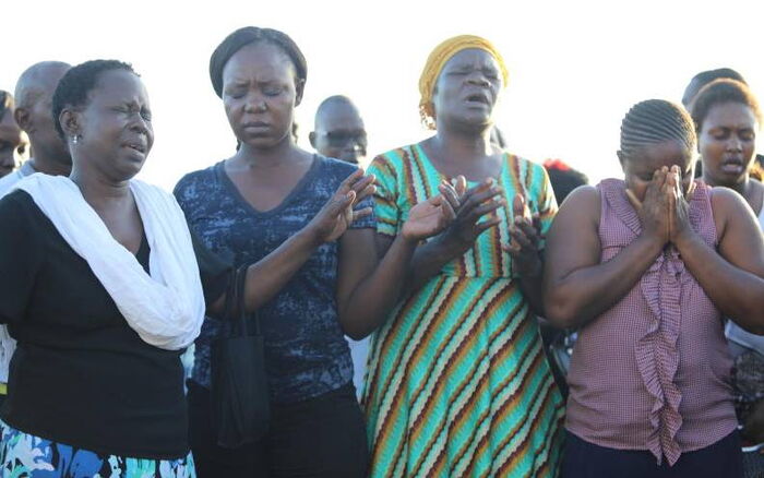 Friends and family pray during a past retrieval exercise.