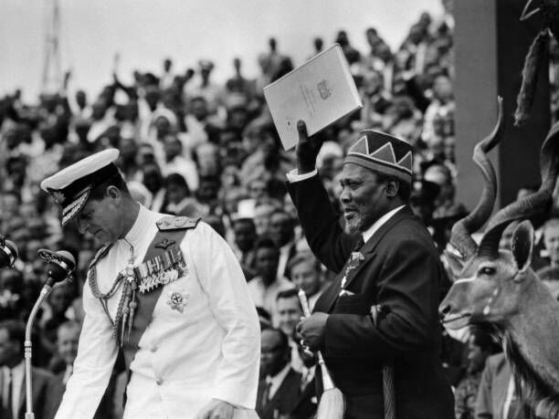 Jomo Kenyatta holds the official document of Kenya's independence in December 13, 1963, in Nairobi as he became President of Kenya. Left is Prince Philip of Edinburgh representing Queen Elizabeth for the ceremony.