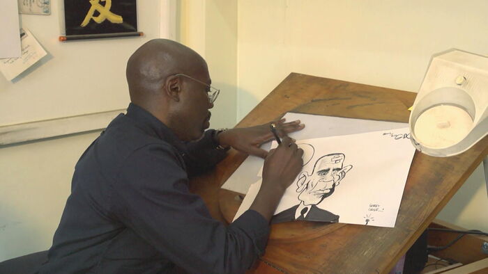 Gado going about his art business in a studio.