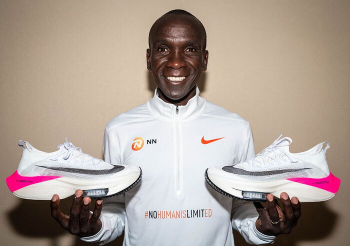 Eliud Kipchoge holding a pair of Nike ZoomX Vaporfly 'NEXT%'. He used the shoes to win the 1:59 challenge in Vienna on October 12, 2019.