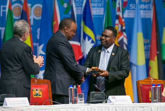 President Uhuru Kenyatta receiving the instruments of power from Davis Madava Steven, Deputy Prime Minister of Papua New Guinea who is the outgoing head of the ACP.