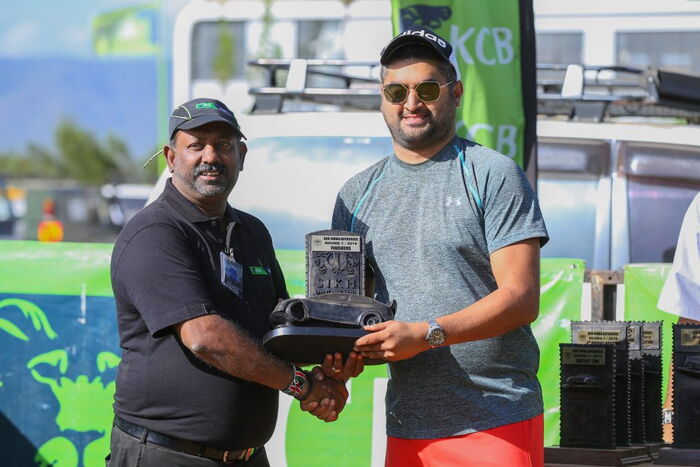 Zameer Verjee (right) receives the winners trophy from Kalpesh Solanki of Sikh Union Club
