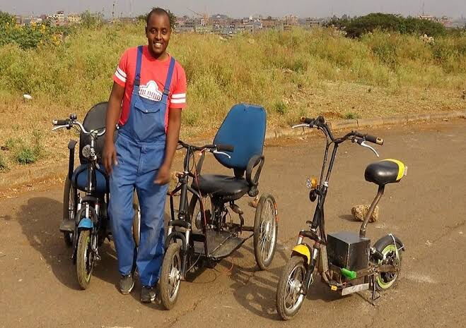 Lincell Technologies founder Lincoln Wamae poses with some of his electric wheelchairs