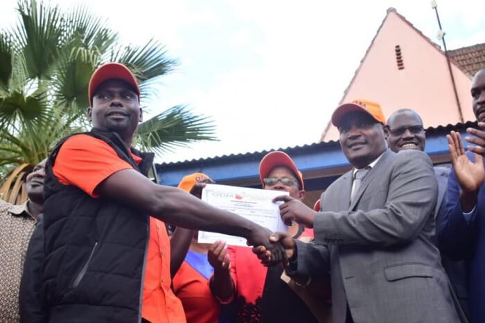 Bernad 'Imran' Okoth receiving his nomination certificate from ODM chairman John Mbadi. The nominations were reportedly biased as stipulated by the Standard.