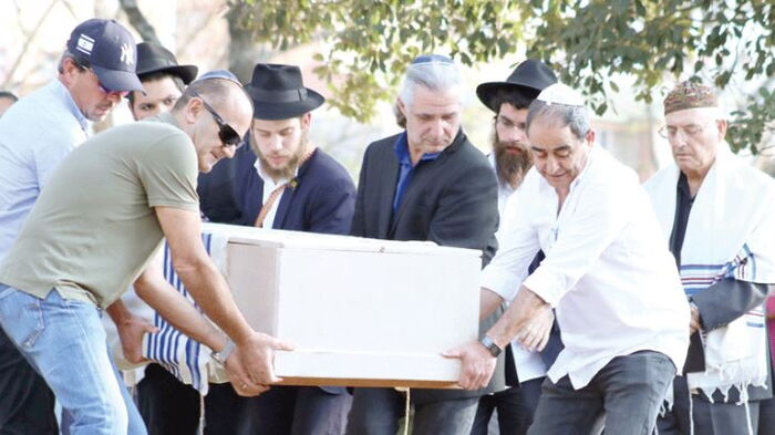 Jewish priests carry Tob Cohen's casket. His brother narrated how the deceased took good care of his wife. 