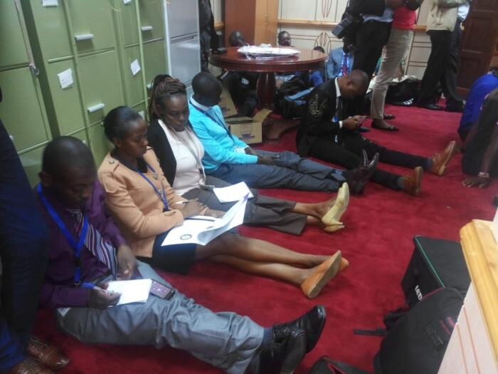 Journalists sit on the floor while covering parliamentary proceedings on 27/6/19 in Committee room 12 TWITTER