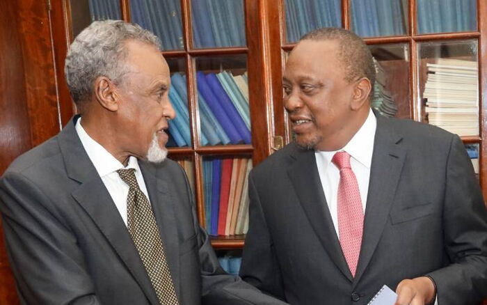 President Uhuru Kenyatta (Right) receives the BBI report from committee chairman Yusuf Haji at State house on November 26