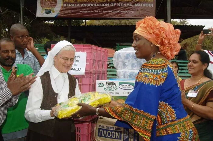 Kalonzo Musyoka's wife Pauline Kalonzo (r) handing out food items.
